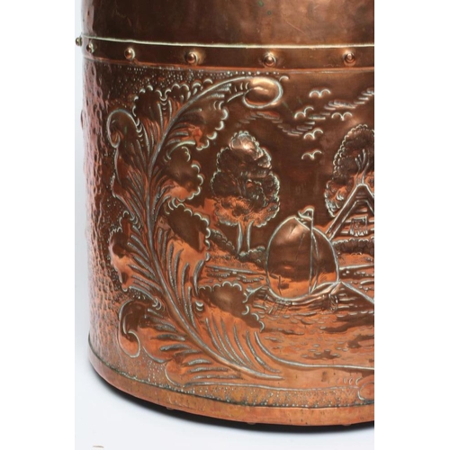 677 - A DUTCH COPPER LOG BIN, early 20th century, of cylindrical form with brass loop handle, repousse wit... 