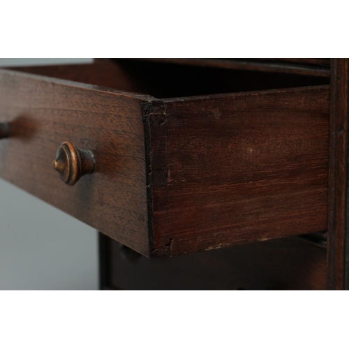 678 - A MAHOGANY MINIATURE CHEST, early/mid 19th century, of two short over three long drawers with turned... 