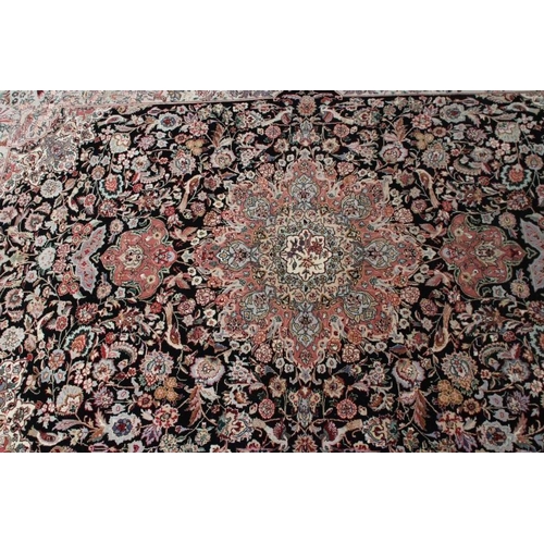 690 - A PERSIAN RUG, the black field with rose pink gul and ivory spandrels within a pale blue border with... 