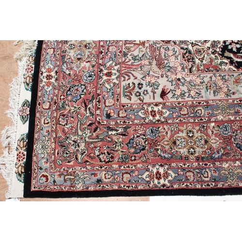 690 - A PERSIAN RUG, the black field with rose pink gul and ivory spandrels within a pale blue border with... 