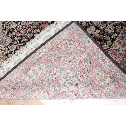 690 - A PERSIAN RUG, the black field with rose pink gul and ivory spandrels within a pale blue border with... 