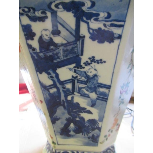 7 - A CHINESE PORCELAIN VASE of swept octagonal form with two scrolling handles, painted in underglaze b... 