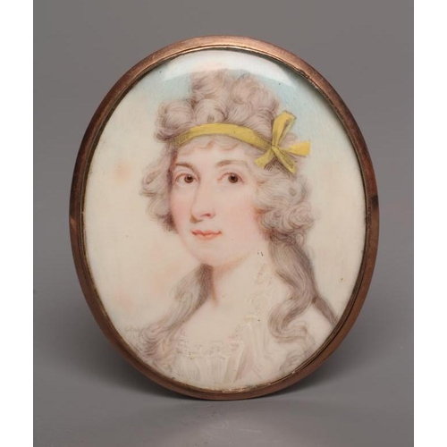 712 - ENGLISH SCHOOL (c.1800) A Lady, wearing a yellow ribbon in her hair, oval miniature on ivory with ha... 