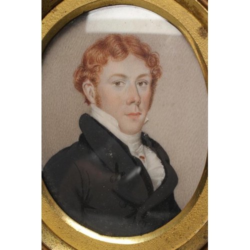 717 - ENGLISH SCHOOL (Early 19th Century) A Gentleman in a black frock coat, oval miniature on ivory, unsi... 