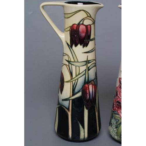 75 - TWO MOORCROFT POTTERY PRETTY PENNY AND FOXGLOVE EWERS of tapering cylindrical form, both designed by... 