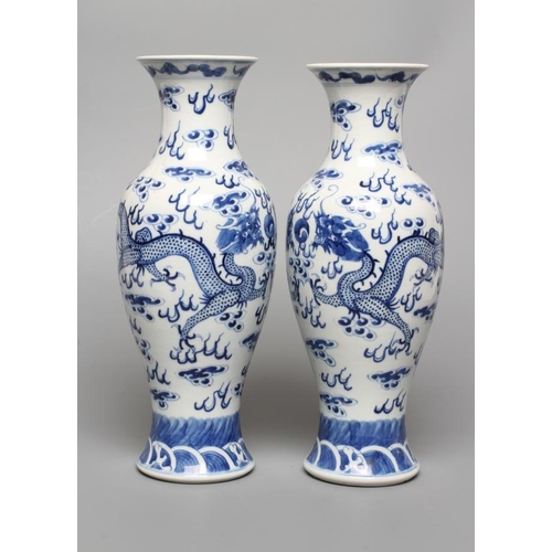 8 - A PAIR OF CHINESE PORCELAIN VASES of inverted baluster form, painted in underglaze blue with two dra... 