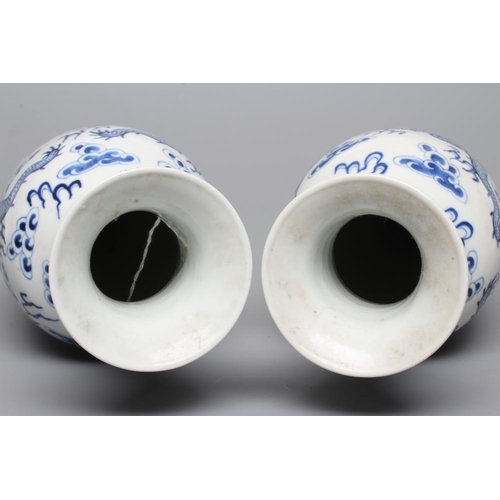 8 - A PAIR OF CHINESE PORCELAIN VASES of inverted baluster form, painted in underglaze blue with two dra... 