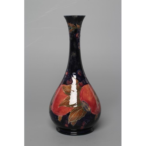 80 - A MOORCROFT POTTERY POMEGRANATE BOTTLE VASE, early 20th century, tubelined and painted in typical pa... 