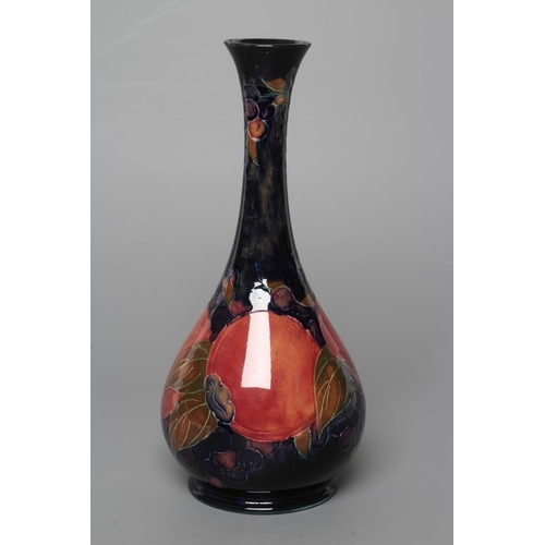 80 - A MOORCROFT POTTERY POMEGRANATE BOTTLE VASE, early 20th century, tubelined and painted in typical pa... 