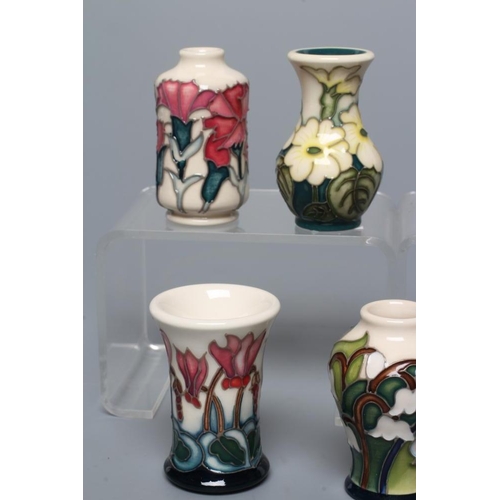 82 - SEVEN MINIATURE MOORCROFT POTTERY VASES, comprising Months of the Year January-Carnation, March-Prim... 