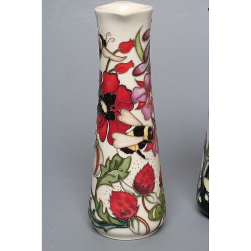 89 - THREE MOORCROFT POTTERY EWERS of tapering cylindrical form, comprising Imagination, 2018, Pollinator... 