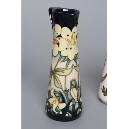 89 - THREE MOORCROFT POTTERY EWERS of tapering cylindrical form, comprising Imagination, 2018, Pollinator... 