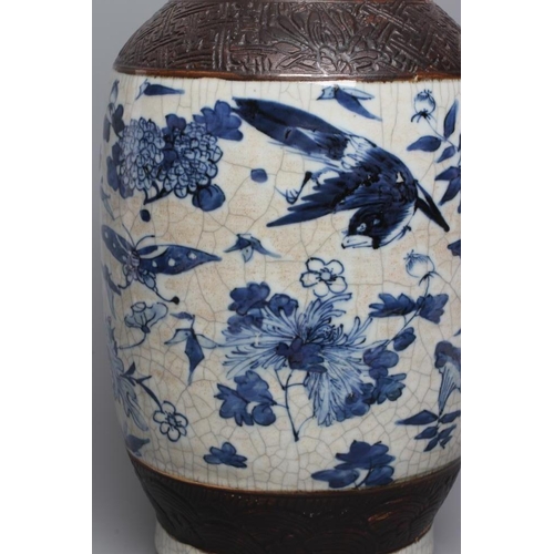 9 - A CHINESE CRACKLE GLAZE VASE with two lug handles, painted in underglaze blue with scattered flowers... 