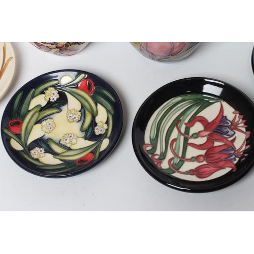 91 - FOUR MOORCROFT POTTERY PIN TRAYS of circular form, comprising Flying Colours (RAF Typhoon Centenary)... 