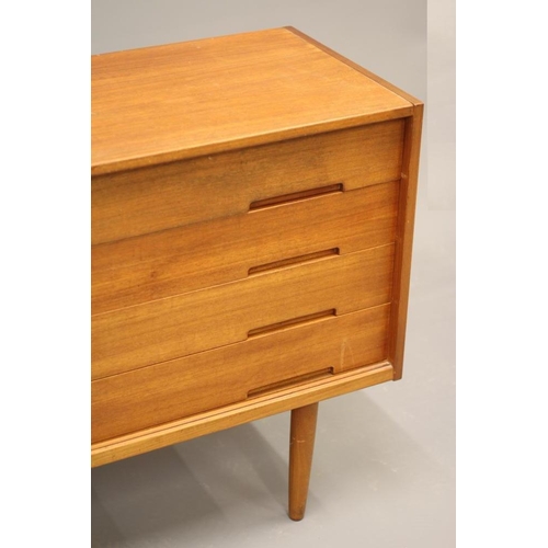 867 - A RETRO TEAK SIDEBOARD, the fascia with four drawers one fitted for cutlery, flanked by a sliding do... 