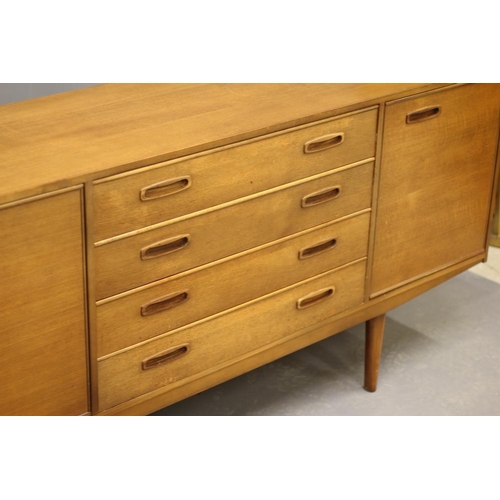 882 - A RETRO TEAK LONG SIDEBOARD of Scandinavian design, the fascia with four drawers with inset oval woo... 