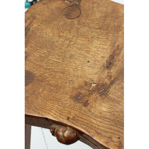 883 - A ROBERT THOMPSON OAK STOOL, the saddle seat with carved mouse trademark in high relief to the edge,... 