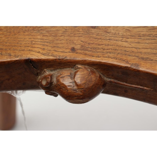 883 - A ROBERT THOMPSON OAK STOOL, the saddle seat with carved mouse trademark in high relief to the edge,... 