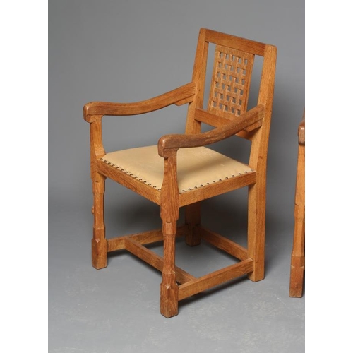 888 - A PAIR OF PETER HEAP OAK ELBOW CHAIRS, the open lattice back with straight top rail, down swept arms... 