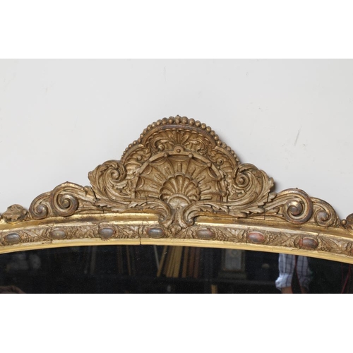 895 - A VICTORIAN GILT GESSO OVERMANTEL MIRROR, the arched plate within a moulded frame with cabochons ami... 