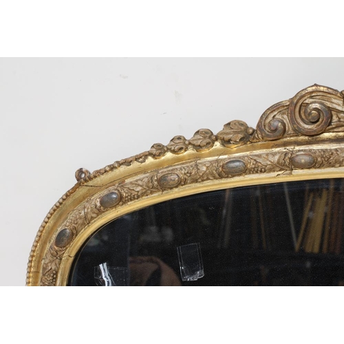 895 - A VICTORIAN GILT GESSO OVERMANTEL MIRROR, the arched plate within a moulded frame with cabochons ami... 