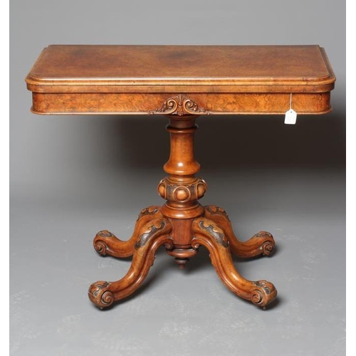 898 - A VICTORIAN BURR WALNUT FOLDING CARD TABLE, the moulded edged rounded oblong top opening to interior... 