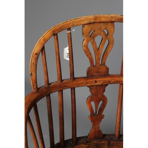 912 - A YEW AND ELM WINDSOR ARMCHAIR, 19th century, of low hoop back form with pierced fleur de lys splat,... 