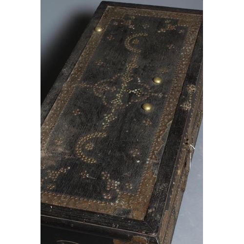 913 - A NORTH AFRICAN EBONY (?) CHEST, c.1900, with brass studwork, the hinged lid with pierced brass hand... 