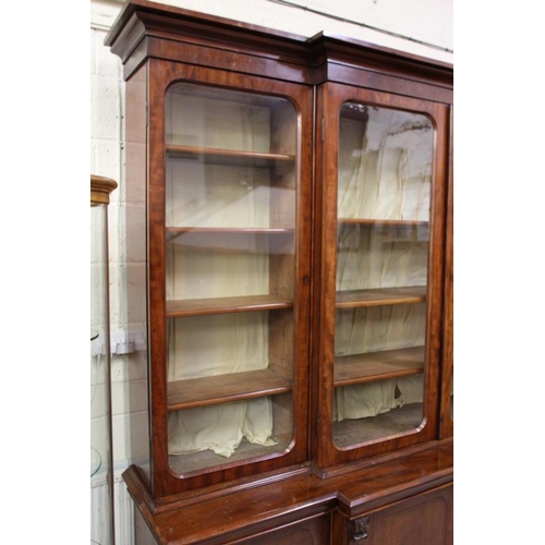 926 - A VICTORIAN MAHOGANY BREAKFRONT LIBRARY BOOKCASE, the moulded cornice over four arched glazed doors,... 