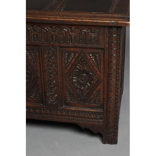 938 - AN OAK PANELLED COFFER, 18th century, the panelled lid opening to a void interior, the four panelled... 