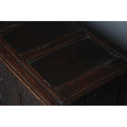 938 - AN OAK PANELLED COFFER, 18th century, the panelled lid opening to a void interior, the four panelled... 