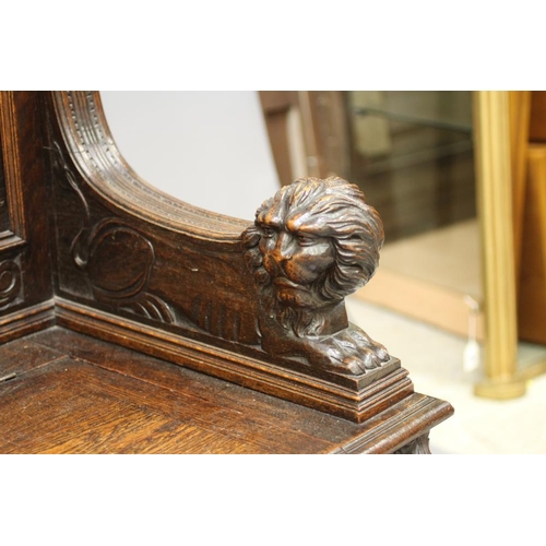 942 - A VICTORIAN CARVED OAK BOX SETTLE, the triple panelled back depicting figure scenes in high relief b... 