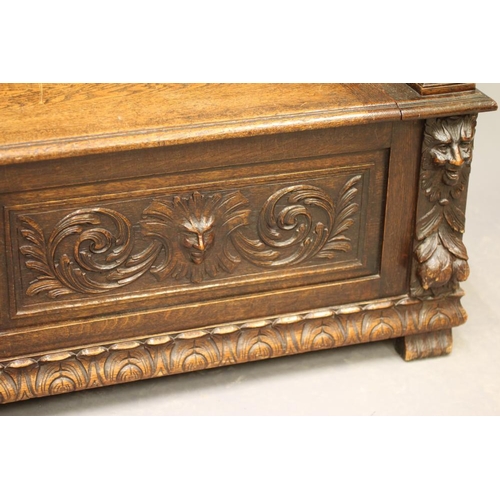 942 - A VICTORIAN CARVED OAK BOX SETTLE, the triple panelled back depicting figure scenes in high relief b... 