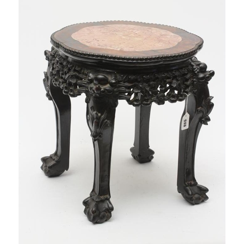 946 - A CHINESE HARDWOOD JARDINIERE STAND, c.1900, of circular form with inset rouge marble top, the shape... 