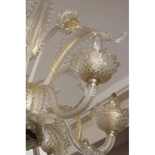 948 - A VENETIAN SIX LIGHT CLEAR GLASS CHANDELIER, early 20th century, the baluster stem with upturned cor... 