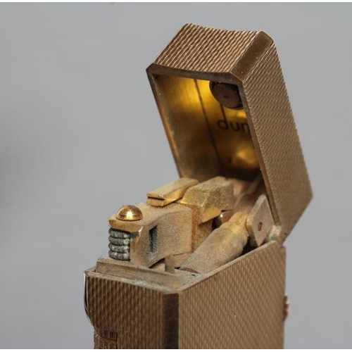 152 - A DUNHILL 9CT GOLD ROLLAGAS CIGARETTE LIGHTER of plain oblong form with engine turning, 2 1/2