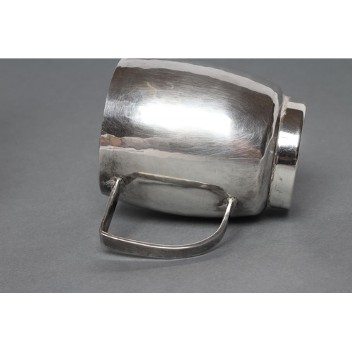 193 - A SMALL SILVER JUG, maker Nancy Goodman, London 1975, of planished slightly bombe cylindrical form w... 