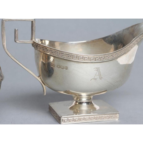 198 - A SILVER SAUCEBOAT, maker Walker & Hall, Sheffield 1924, the plain oval bowl with Greek key cast and... 