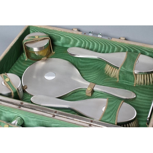 212 - AN ART DECO TRAVELLING CASE, makers G. Carsberg & Son, London 1940, comprising circular bevelled han... 