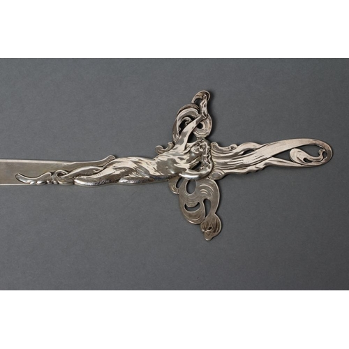 213 - AN ART NOUVEAU STYLE SILVER PAPER KNIFE, stamped STERLING, the handle single struck with a scantily ... 