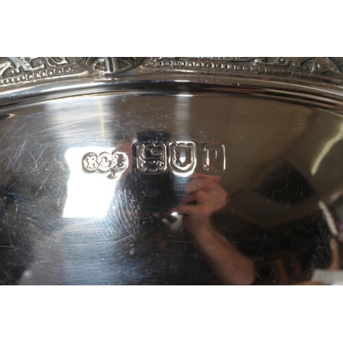 216 - AN EDWARDIAN SILVER CELTIC STYLE PORRINGER, maker Reid & Sons, London 1910, of circular form, the tw... 