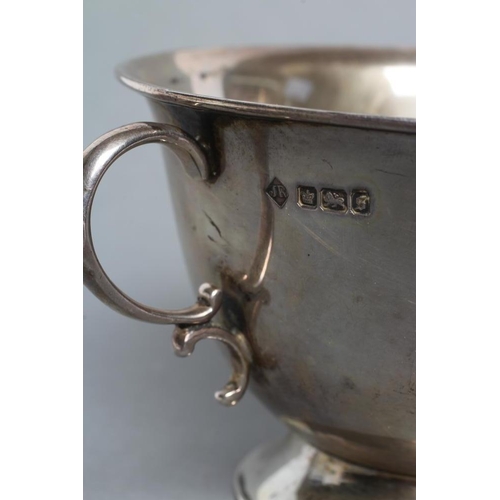 240 - AN EDWARDIAN SILVER PORRINGER, maker A. J. Ramsey, Sheffield 1910, with double C scroll handles on a... 