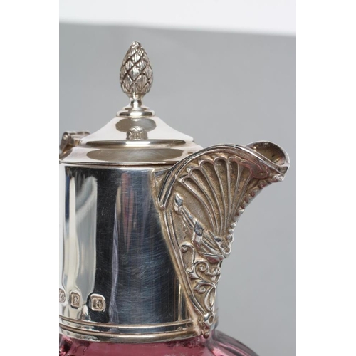 279 - A SILVER MOUNTED CRANBERRY GLASS CLARET JUG, maker's mark WW, London 2001, the lightly ribbed ovoid ... 