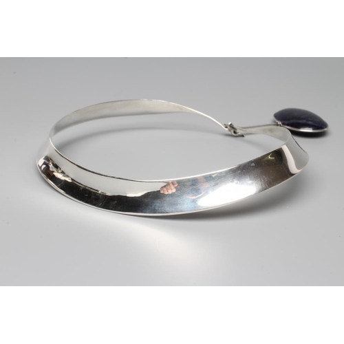 441 - A GEORG JENSEN SILVER NECK RING designed by Vivianna Torun Bulow-Hube, with tension clamp and hung w... 