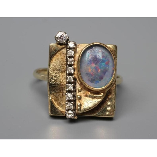 464 - A SECESSIONIST STYLE COCKTAIL RING, the square panel close back collet set with an oval cabochon pol... 