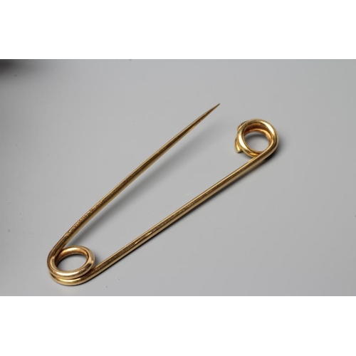 465 - A CARTIER KILT PIN of simple twisted wire with a loop to each end, one forming the clasp, engraved C... 