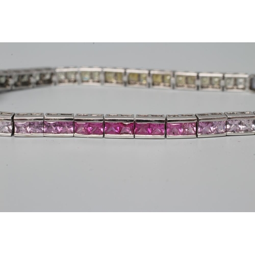 467 - A RAINBOW SAPPHIRE TENNIS BRACELET, compirising sixty eight calibre cut stones graduating through gr... 