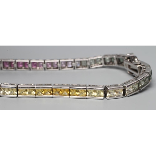 467 - A RAINBOW SAPPHIRE TENNIS BRACELET, compirising sixty eight calibre cut stones graduating through gr... 