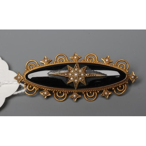 469 - A VICTORIAN MOURNING BROOCH, the eliptical black panel centred by a gypsy set and seed pearl star, w... 