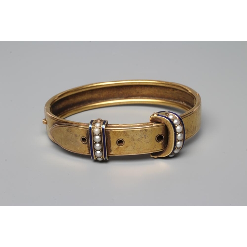 470 - A VICTORIAN STIFF HINGED BUCKLE BANGLE, the upper section with two seed pearl and blue enamel 